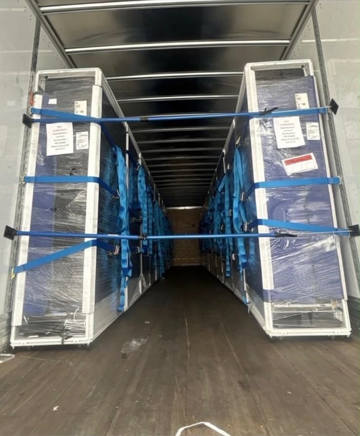 Wrapped GPU rack cabinets secured inside a shipment trailer